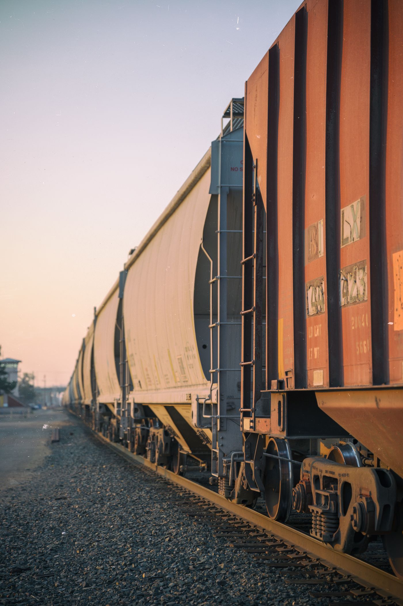 Covered hopper and other bulk commodity freight cars on railway tracks